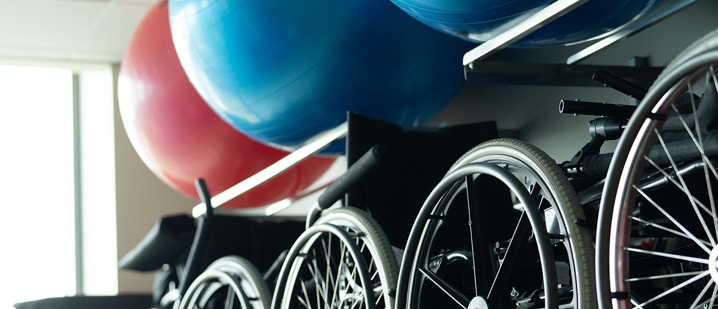 Bikes and stability balls on wall racks.